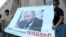 Armenia - Youth activists hold up a banner demanding the resignation of Henrik Navasardian, Yerevan's public transport chief, 28Jul2013 