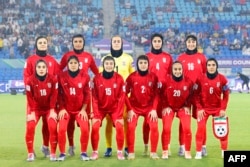 Iran’s women's soccer team poses for a group photo before their Asian Cup game with the Philippines on March 8.
