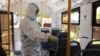 KYRGYZSTAN -- Bishkek - COVID-19 - coronavirus - worker in protective uniform disinfects buses in Bishkek - Bishkek city administration intensifies disinfection in public transport June 21, 2021