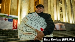 გურამ ქუხილავა თავისი საპროტესტო ბანერებით, რომლებსაც ბოლო ერთი წლის განმავლობაში ამზადებდა აქციებისთვის