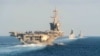 (L-R) The aircraft carrier USS Abraham Lincoln (L), the air-defense destroyer HMS Defender and the guided-missile destroyer USS Farragut transit the Strait of Hormuz, November 19, 2019