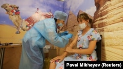 A woman receives a dose of Sputnik V vaccine at a temporary vaccination unit in Almaty on June 23.