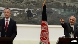 Afghan President Ashraf Ghani (L) speaks during a press conference as new NATO chief Jens Stoltenberg looks on at the Presidential Palace in Kabul on November 6, 2014.