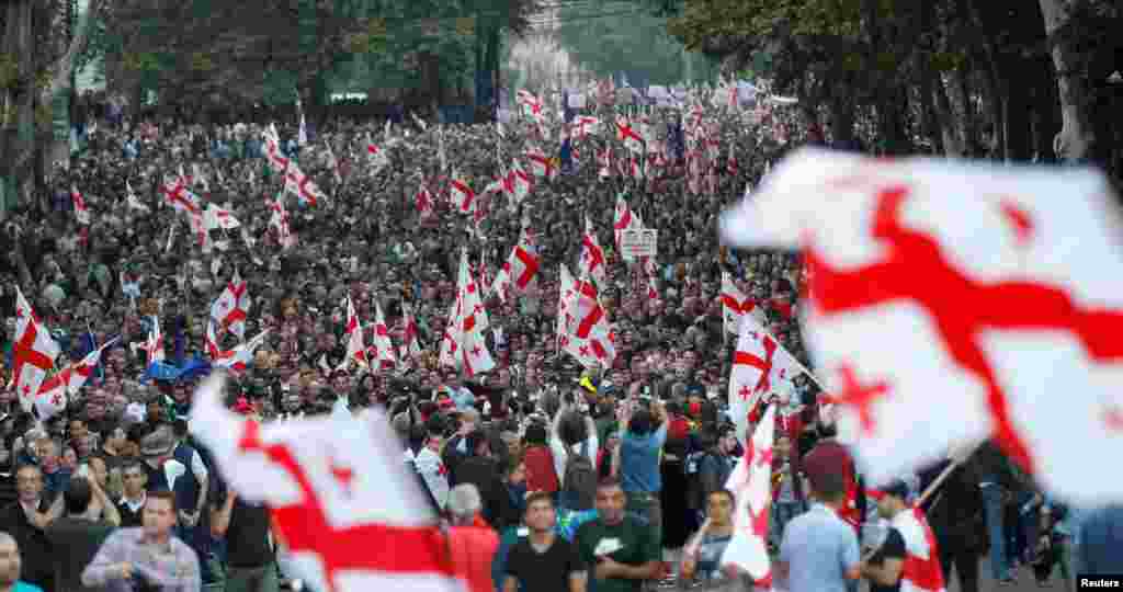 Supporters of Georgia's largest opposition party, the United National Movement, march during a rally ahead of upcoming parliamentary elections in Tbilisi. (Reuters/David Mdzinarishvili)