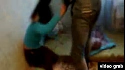 A screen grab from a video showing "Ajna," a Kyrgyz woman being beaten by male compatriots, purportedly for associating with non-Kyrgyz men.