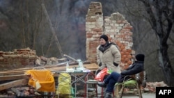 Na terenu potresom pogođene Sisačko-moslavačke županije nalazi se više od 10 mobilnih timova Crvenog križa za psihosocijalnu podršku (fotografija: stanovnici Petrinje ispred srušene kuće, 2. siječanj 2021