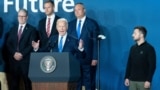 U.S. President Joe Biden speaks at the conclusion of the NATO summit in Washington on July 11, as Ukrainian President Volodymyr Zelenskiy (right) and other other foreign leaders look on.