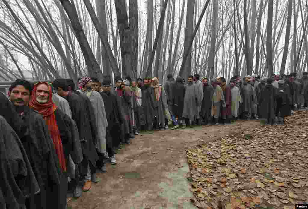 Voters line up to cast their votes outside a polling station during the first phase of of voting in state assembly elections in Jammu and Kashmir, which is administered by India, on November 25. (Reuters/Danish Ismail)