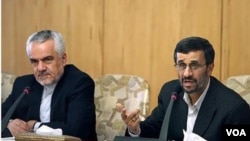 Iranian President Mahmud Ahmadinejad (right) attends a conference with his first vice president, Mohammad Reza Rahimi.