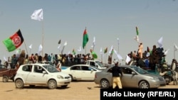 FILE: Afghan celebrate a three-day cease-fire in June 2018.