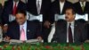 Pakistani President Asif Ali Zardari (left) signing a constitutional reform law as Prime Minister Yousuf Raza Gilani (R) looks on during a ceremony in Islamabad in April 2010.