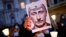 ITALY – A protester holds a picture of Russian President Vladimir Putin with a moustache and a symbol of swastika to resemble the Nazi dictator Adolf Hitler. Italy, February 25, 2022