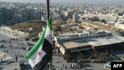 SYRIA - A Syrian opposition flag flies above a market square in central Aleppo captured by Jihadists and their Turkish-backed allies, November 30, 2024. 