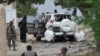 Pakistani security officials examine the site of a powerful explosion in Mastung district in the southwestern province of Balochistan on May 12.