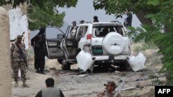 Pakistani security officials examine the site of a powerful explosion in Mastung district in the southwestern province of Balochistan on May 12.