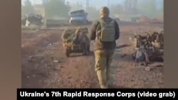 A soldier from Ukraine's 7th Rapid Response Corps walking behind a ground drone in footage released on November 4 from the eastern city of Pokrovsk.
