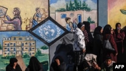 Палестинцы стоят в очереди за помощью перед центром БАПОР на юге сектора Газа, 28 января 2024 года
