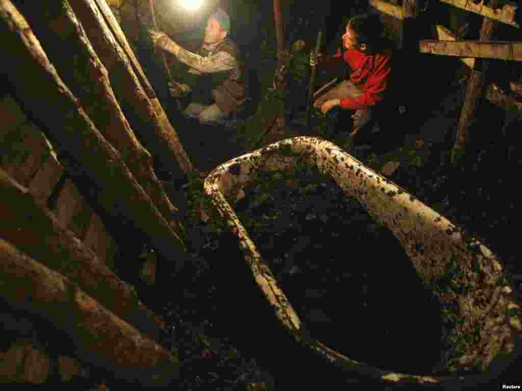 Illegal miners dig coal in the village of Stranjani, near Zenica, on October 26. There are about 20 illegal mines in the area, where Bosnians dig for coal with their bare hands and use primitive tools such as bathtubs to transport the coal. Photo by Dado Ruvic for Reuters