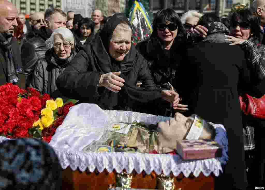 The mother of Ukrainian serviceman Dmytro Godzenko, who was killed in fighting in eastern Ukraine, reacts during his funeral ceremony on Independence Square in central Kyiv on April 3. (Reuters/Gleb Garanich)