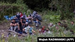 Migranti za koje se vjeruje da su iz Afganistana sjede u malom selu Usnarz Gorny blizu Bialystoka, na sjeveroistoku Poljske, koje se nalazi blizu granice s Bjelorusijom, 20. augusta 2021. godine.