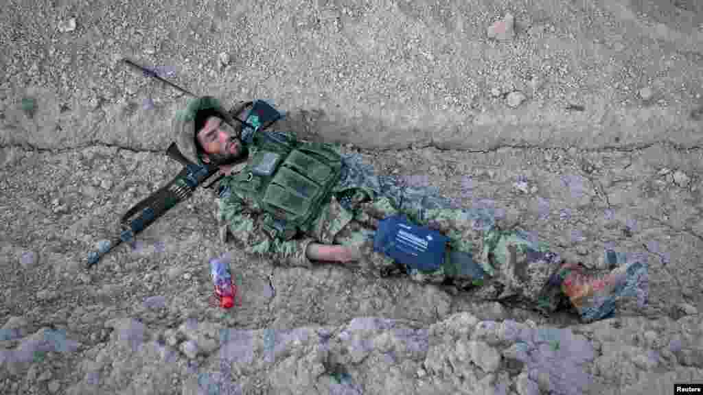 An Afghan National Army (ANA) soldier takes a nap before an early morning joint patrol with U.S. soldiers in a village in Logar Province on May 22. (Reuters/Danish Siddiqui)