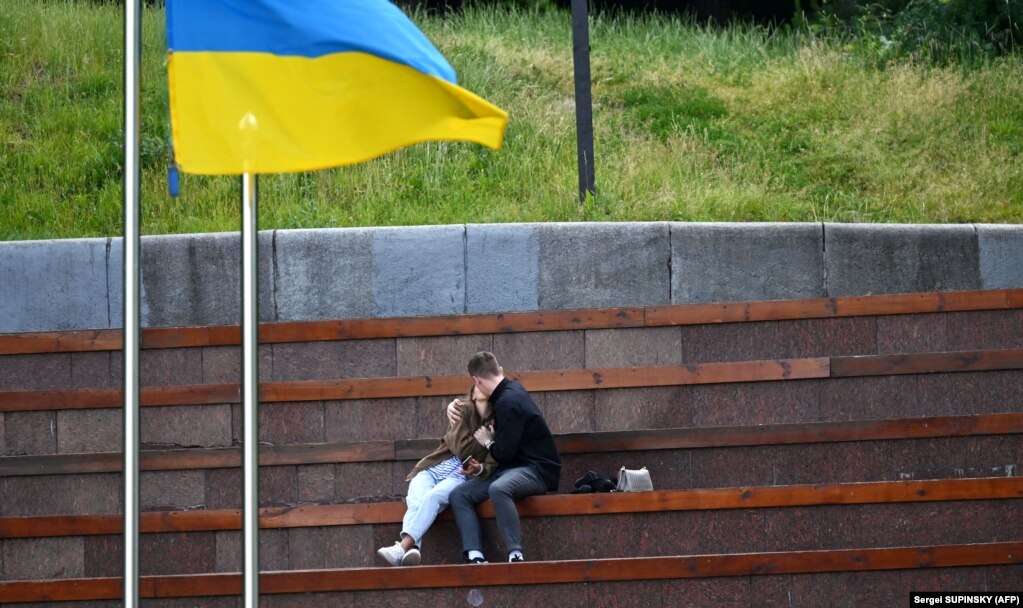 A young couple kisses in a park in the center of Kyiv on June 22.