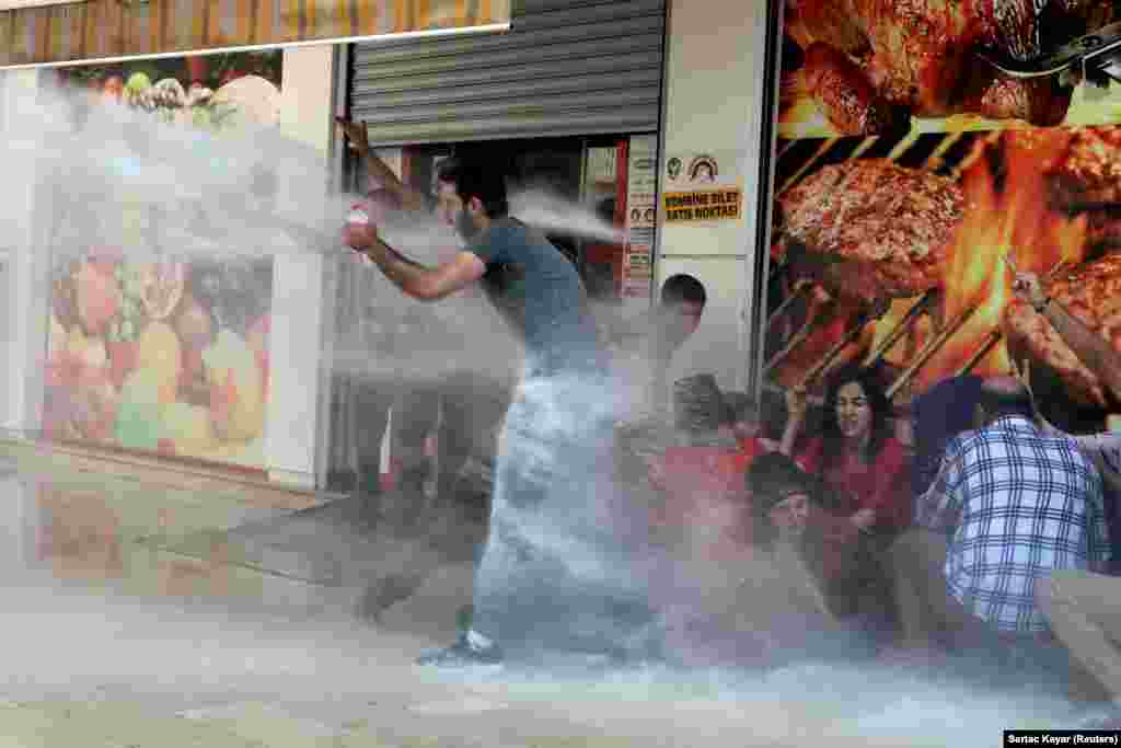 Turkish police use a water cannon to disperse demonstrators in Diyarbakir during a protest against the replacement of Kurdish mayors with state officials in three cities on August 19. (Reuters/Sertac Kayar)