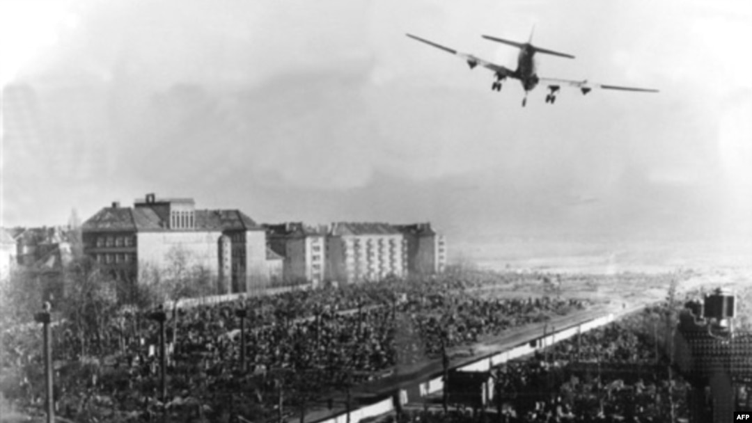A U.S. transport aircraft flies over Berlin's Tempelhof Airport in June 1948 