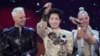 Flanked by Russia's Shaman (left) and Belarus's Nastya Kravchenko (right), Vietnam's Duc Phuc celebrates winning the Intervision Song Contest on September 20. 