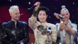 Flanked by Russia's Shaman (left) and Belarus's Nastya Kravchenko (right), Vietnam's Duc Phuc celebrates winning the Intervision Song Contest on September 20. 