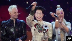 Flanked by Russia's Shaman (left) and Belarus's Nastya Kravchenko (right), Vietnam's Duc Phuc celebrates winning the Intervision Song Contest on September 20. 
