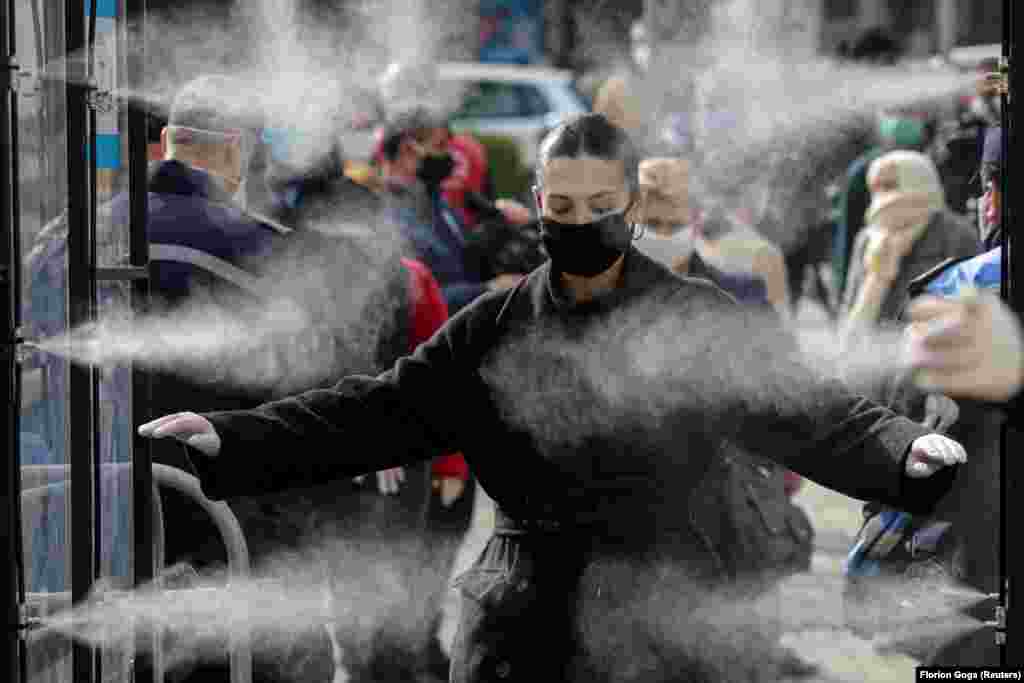 Albanian shoppers are disinfected before entering a market in Tirana. (Reuters/Florion Goga)