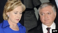 U.S. Secretary of State Hillary Clinton speaks with Armenian Foreign Minister Eduard Nalbandian after the signing ceremony on October 10