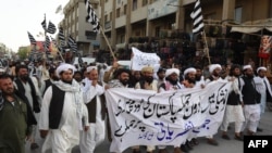 FILE: Activists of pro-Taliban Jamiat Ulema-i-Islam-Nazaryati (JUI-N) protest the killing of Taliban leader Mullah Akhtar Mohammad Mansur in a U.S. drone strike in May.