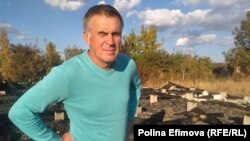 Sergei Shalygin, a Russian opposition activist and blogger, stands in front of his destroyed home in Rostov-on-Don. "The only reason I can see for the arson attack is my political activism," he says.