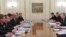 Russian President Vladimir Putin (right) speaks at a meeting with top officials on gas deliveries to Ukraine at his Novo-Ogaryovo state residence outside Moscow on April 10.