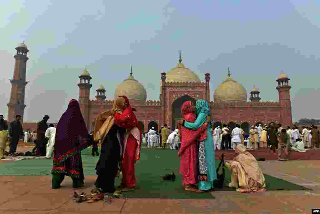 Pakistani Muslim devotees hug each other to celebrate Eid after offering the Eid al-Adha prayers at the Badshahi Mosque in Lahore, Pakistan, on&nbsp;October 6. (AFP/Arif Ali) 