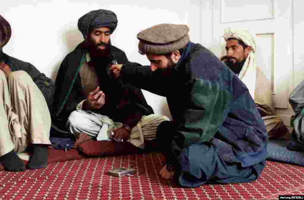 RFE/RL reporter interviewing Afghan tribal members in 2010.