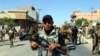 File - Members of Iraqi Shiite group known as Hashd al-Shaabi (The Popular Crowd) patrol an area in Tuz, southern Kirkuk city, Iraq, 17 October 2017.