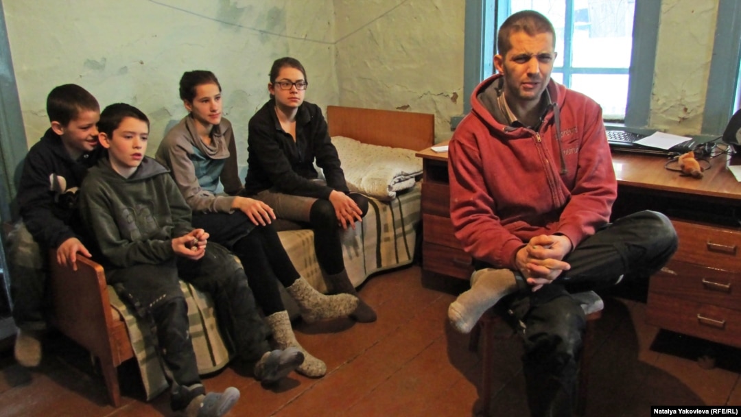 Eugen Martens with some of his 10 children whom he and his wife relocated from "sexually permissive" Germany to a remote village in Siberia, where they intend to "live by the Bible."