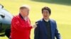 Japan's Prime Minister Shinzo Abe (R) listens to US President Donald Trump as they walk before playing a round of golf at Mobara Country Club in Chiba on May 26, 2019.