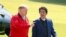 Japan's Prime Minister Shinzo Abe (R) listens to US President Donald Trump as they walk before playing a round of golf at Mobara Country Club in Chiba on May 26, 2019. 