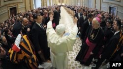 Pope Benedict XVI waves as he arrives at a private audience at the Vatican in 2011.