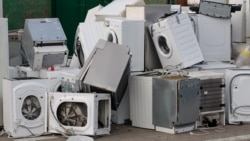 Old electrical appliances in container of recycling center.