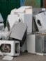 Old electrical appliances in container of recycling center.