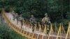 Indian border guards patrol on a footbridge built over a stream near the Line of Control (LoC), a cease-fire boundary that divides Kashmir between India and Pakistan. (file photo)