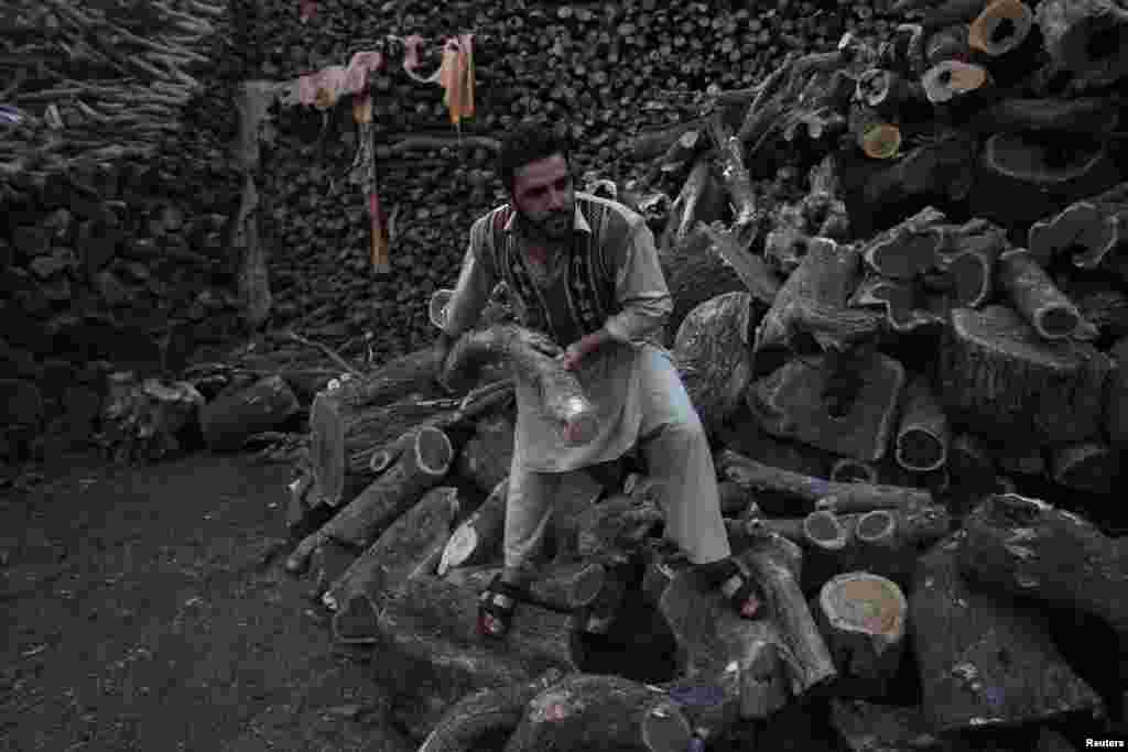 A man arranges firewood for sale in Peshawar, Pakistan. (Reuters/Fayaz Aziz)