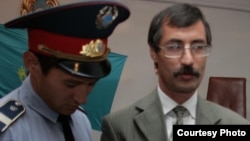 Полицейский производит арест правозащитника Евгения Жовтиса в зале суда. Поселок Баканас Алматинской области, 3 сентября 2009 года.