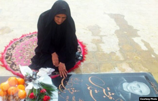 Gohar Eshghi sits next to her son's grave.