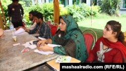 Workers at a by-election polling station in Islamabad on August 22. 